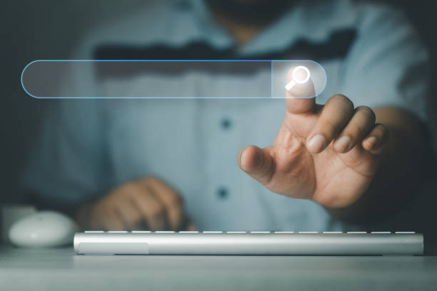 istock Search button on virtual screen pressed with finger. Concept of SEO 1558352840