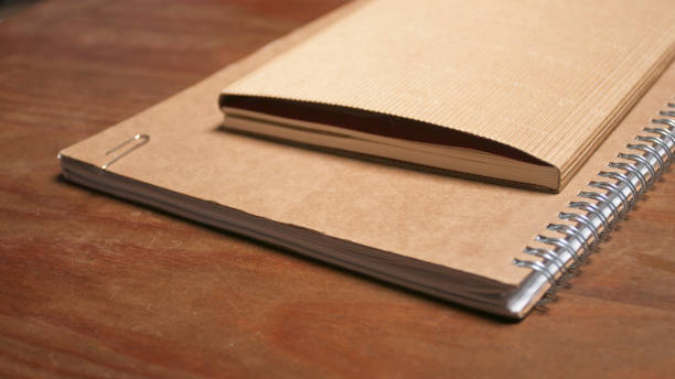 istock Cardboard cover  notebook on wooden table 1558362830