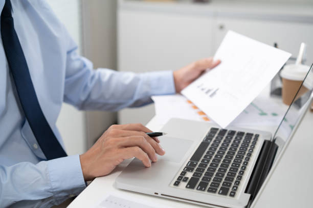 istock Business man working by using laptop computer Hands typing on a keyboard. Professional investor working new start up project. business planning in office. Technology business 1558376398