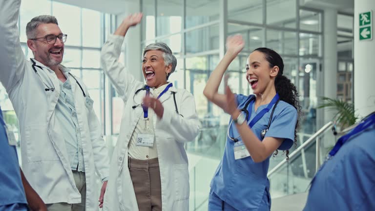 Clapping, celebrate and team of doctors in hospital cheering for a surgery success or goal. Happy, smile and group of professional healthcare workers with applause for collaboration in medical clinic