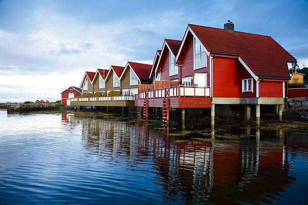 Red wooden cabins at campsite by the fjord in Molde, Norway