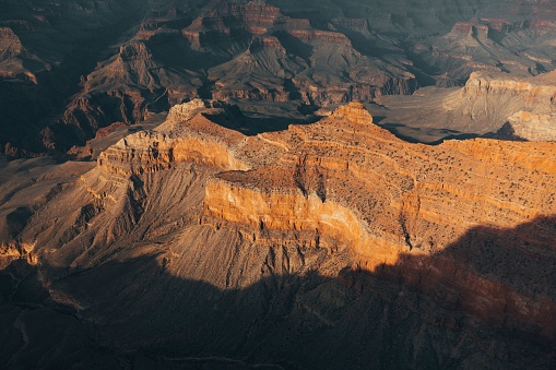 A picturesque view of a rugged sandstone canyon landscape during sunset
