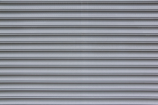 close-up detail of closed corrugated metal security shutter