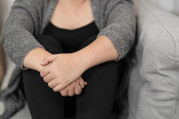 istock Sad Overweight plus size woman thinking about problems on sofa upset girl feeling lonely and sad from bad relationship or Depressed woman disorder mental health. 1558389095