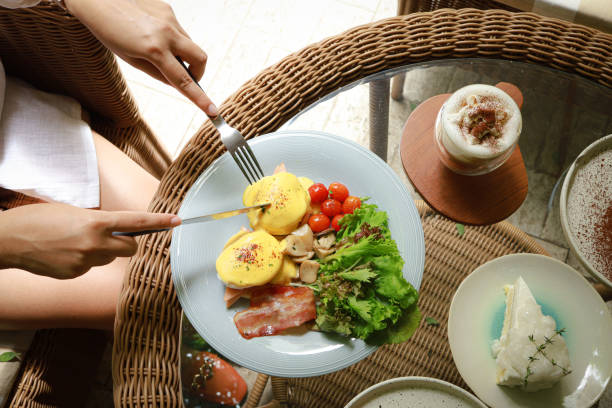 istock Breakfast Eggs Benedict toasted English muffins. Delicious breakfast with eggs Benedict 1558389799