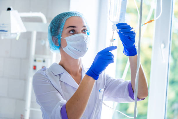 istock General practitioner is preparing drop counter to a patient for procedure in hospital 1558401625