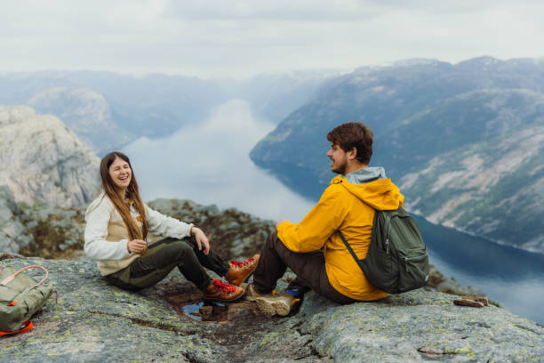 Happy Woman and Man Admiring Idyllic View of Lysefjord from Above in Norway stock photo