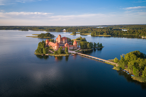 Trakai, Lithuania - June 10, 2019: Trakai Castle with lake and forest in background. One of the most famous Sightseeing place in Lithuania