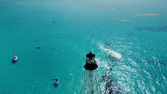An aerial view of boats sailing in the vicinity of Crocodile Reef Lighthouse in the United States