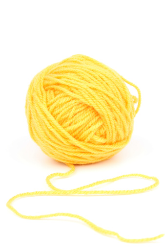 Yellow wool on white background.