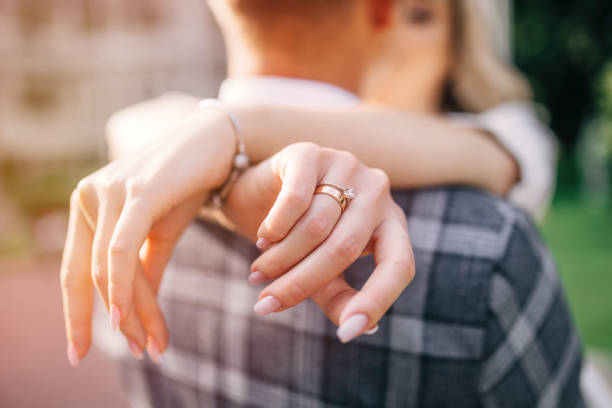 istock Wedding ring and hands close up. Wedding day. Young happy newlyw 1558493911