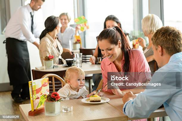 Couple Feeding Their Child Cake At Cafe Stock Photo - Download Image Now - Adult, Cafe, Cake