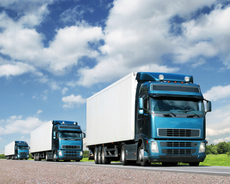 caravan of trucks on country highway, cargo transportation concept