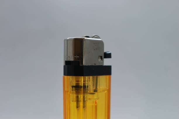 istock a very nice yellow gas lighter on a bright white background 1558517228