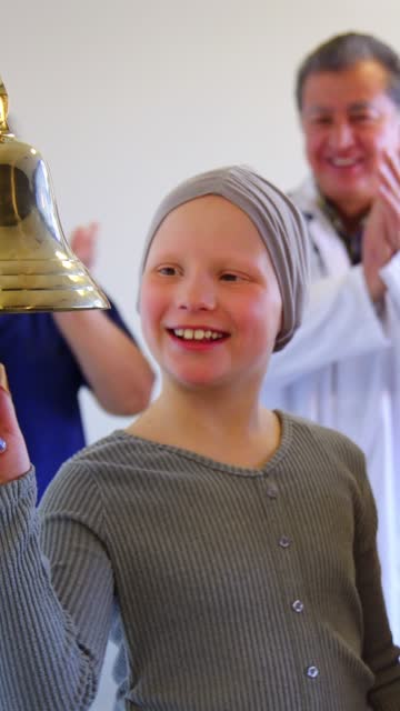 Child Chemotherapy Patient Finishing Treatment with a Ceremonial Bell Ring