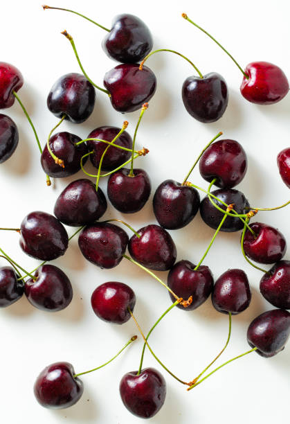 istock ripe and fresh cherries on a white background. harvest. fruit shop 1558559148
