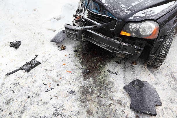 Broken car on road in winter; crash accident stock photo