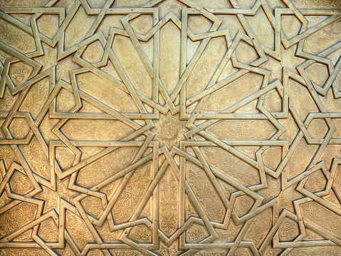 Golden door detail of the royal palace gate in Fez, Morocco. Abstract background image