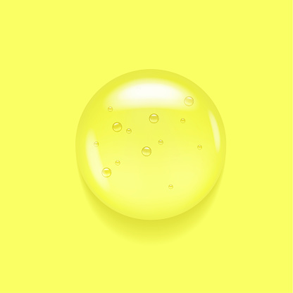Transparent serum swatch on yellow lemon background. Essential glycerin cream toner concept. Oily moisture smear puddle. Round wash fuid microscope realistic blob
