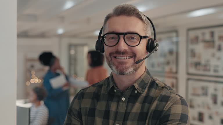 Happy man, call center or face of manager with arms crossed in customer service or telemarketing. Proud, portrait or confident senior consultant agent with headphones, success or smile at workplace