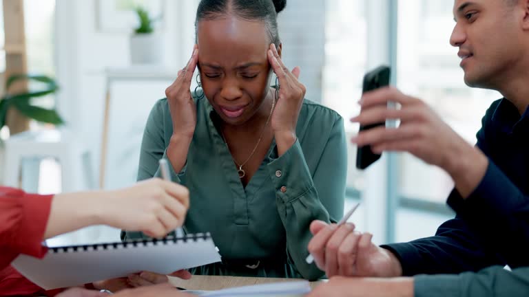 Headache, anxiety and black woman in office with chaos, frustration and overwhelmed with team, report or deadline. Migraine, stress and lady manager with group documents for tax, audit or compliance