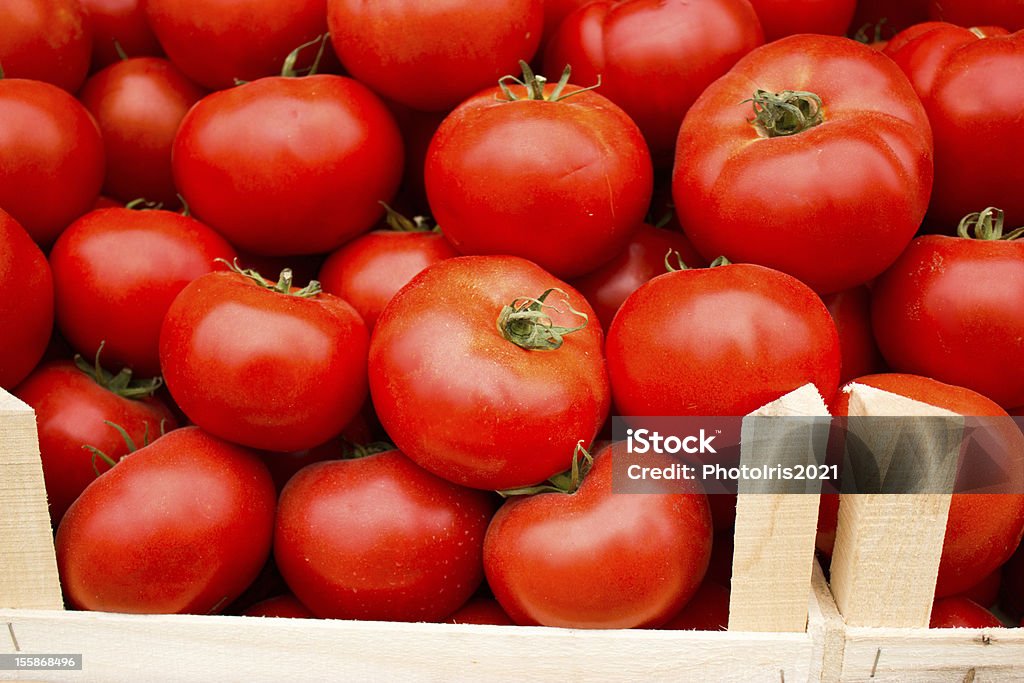 Fresh organic tomato in crates Fresh organic tomato is ready for transport Agriculture Stock Photo