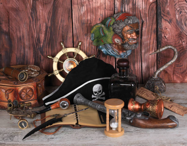 A young bearded man and a young pretty woman dressed in pirate costumes. They are performing a comic fight with pistols. Studio shot on a white background