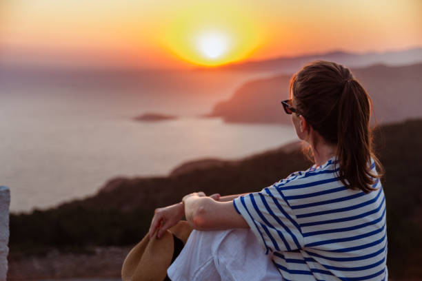 istock Young woman looking at horizon over sea 1558705515