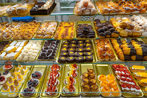 confectionery bakery variety of traditional colorful cakes in a counter in Porto Portugal .