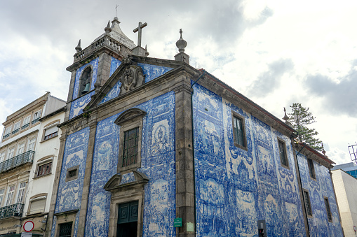 chapel of souls capela das almas with beautiful blue white azulejo tiles facade in Porto Portugal .