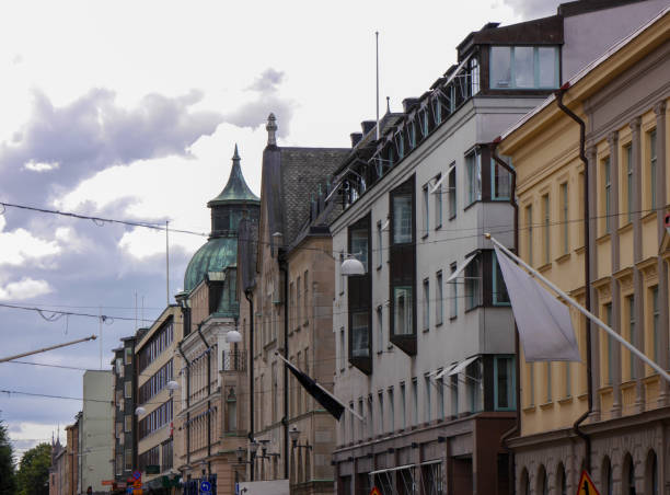 istock Low angle view of a buildings against cloudy sky 1558731558