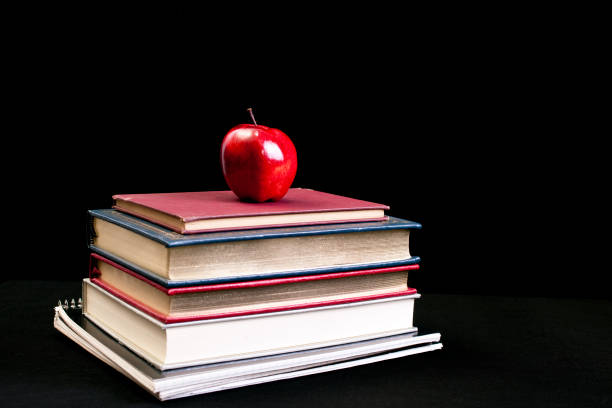 istock Books and apple with black background 155875953