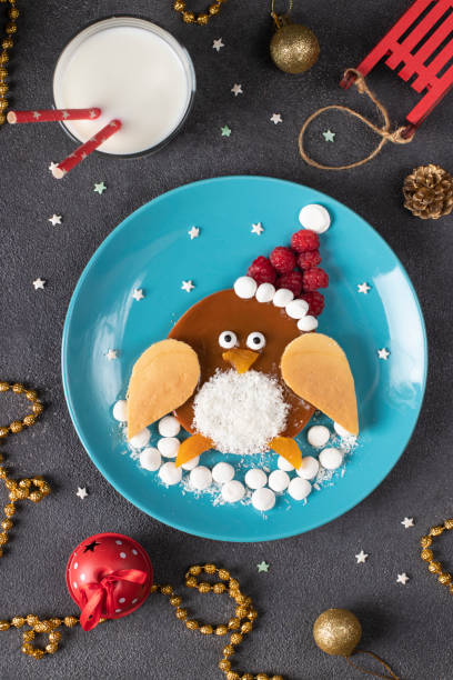 istock Penguin form pancake with raspberry for breakfast - fun food idea for kids, Top view 1558769183