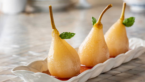 Roasted Pears with syrup, Baked pear, Roasted Pears with Honey, Caramelized pears, Traditional poached pear dessert with syrup stock photo