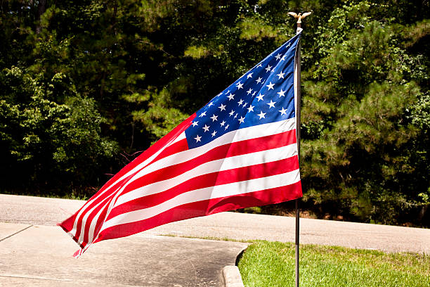 istock American flag in front yard of home 155879289
