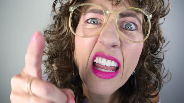 Close Up of Angry Middle Aged Woman With Permed 80s Hair and Glasses