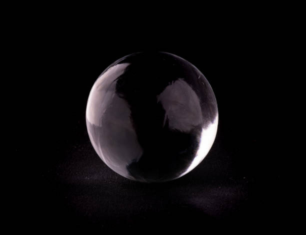 istock crystalline translucent ice and crystal sphere isolated on black background 1558806705