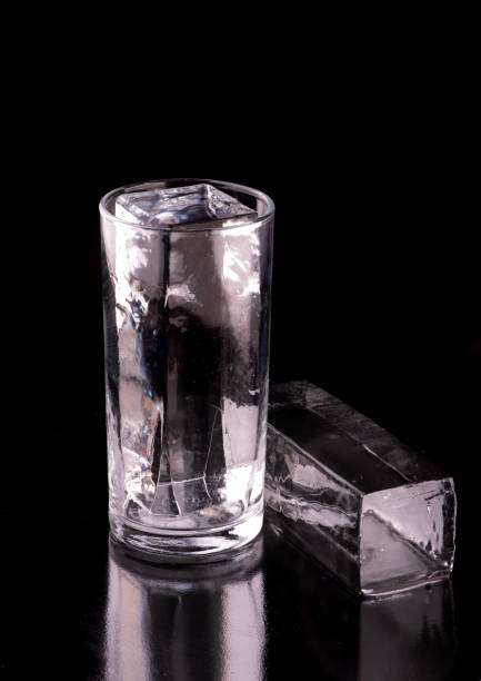 istock crystalline translucent ice for long drink drinks in empty glass on black background 1558806875