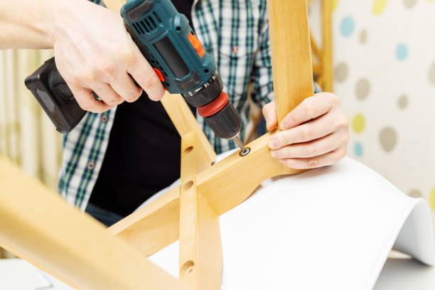 istock Craftsman collecting with tools, assembling furniture with screwdriver 1558820485