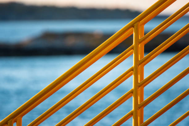 Yellow metal hand railings on a ferry.