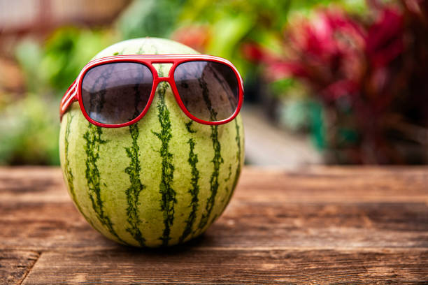 Fun Summer Time Watermelon with Sunglasses on a wood table