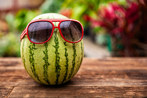 Fun Summer Time Watermelon with Sunglasses on a wood table