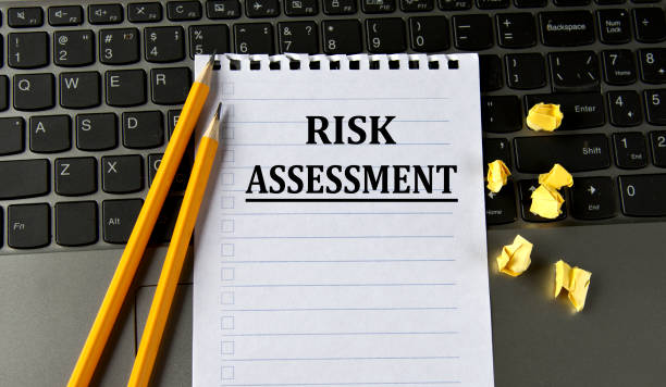 istock RISK ASSESSMENT - words in a white notepad on the background of a laptop with pencils 1558828241