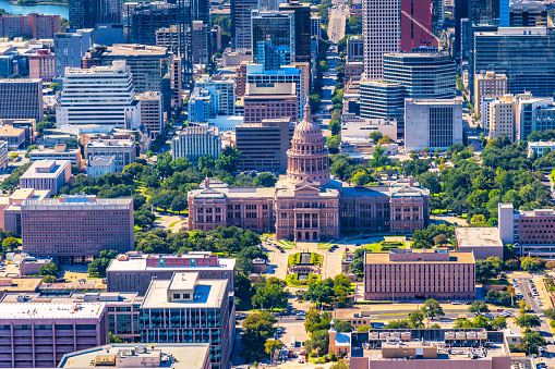 Aerial view of the iconic Texas State Capitol Building located in Austin, Texas shot from an altitude of approximately 1000 feet over the city.