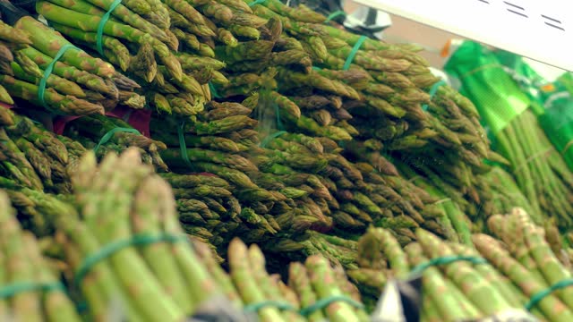 asparagus in supermarket. edible asparagus. grocery supermarket. supermarket. vegetables and fruits. grocery section in a supermarket. grocery store. shopping. products. goods in the store. shopping in the store.