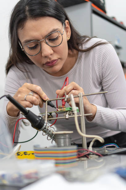 istock Latin woman learns robotics at university 1558890482
