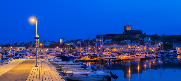 The port and a blue hour view at the castle of a small island and town of Marstrand, located in the municipality of Kungalv in southern Bohuslan, on the west coast
