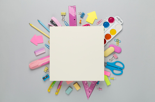 Various school stationery with space for text on color background, top view