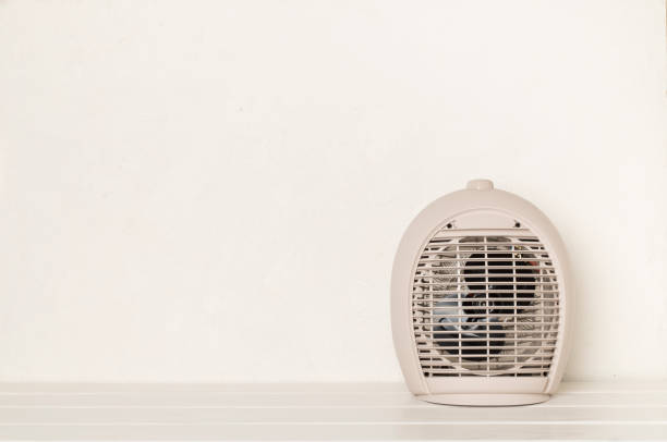 istock Modern electric fan heater on light table 1558923431