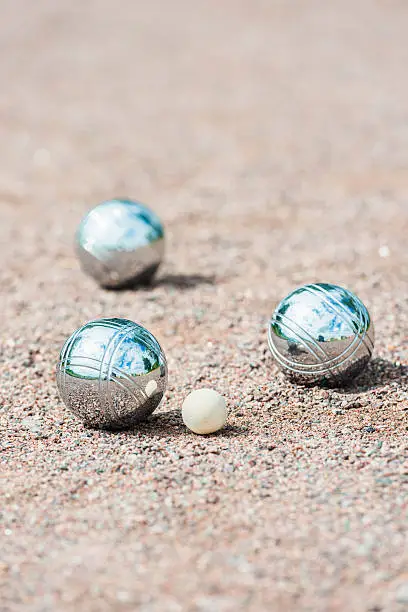 Game of boule being played on sand